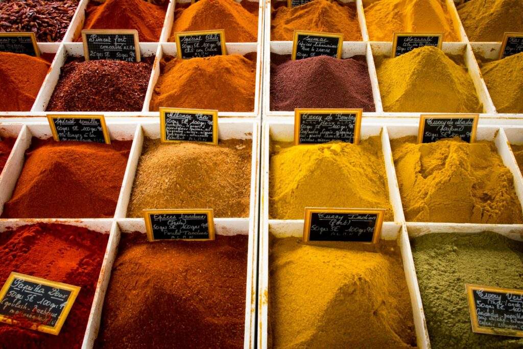 Assorted whole and ground spices in bowls