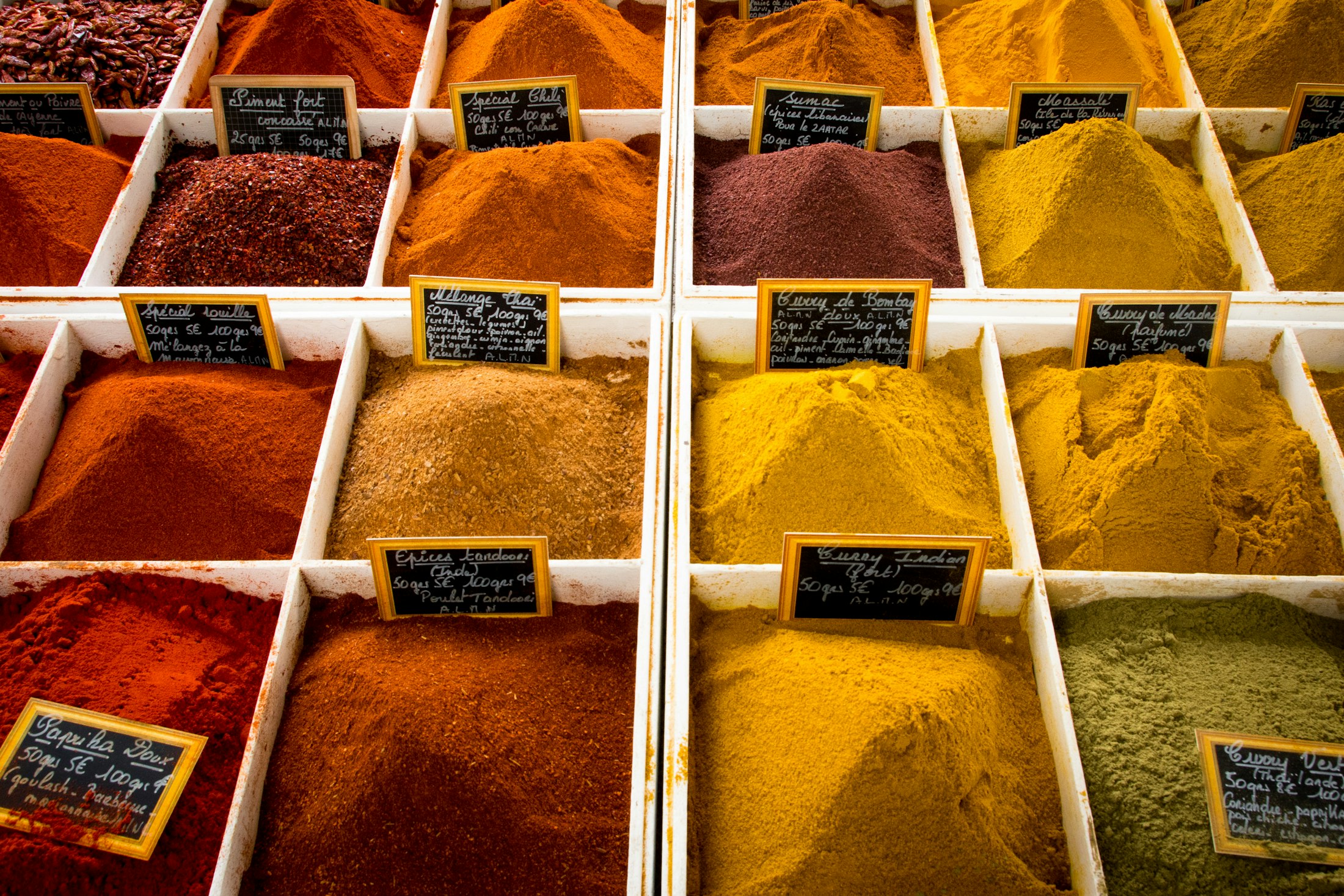Assorted whole and ground spices in bowls